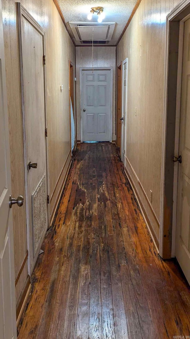 520 Main St, Newport, AR 72112 - corridor with wooden walls, a textured ceiling, and dark wood-type flooring