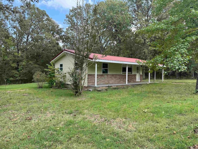 view of property exterior with a porch and a lawn