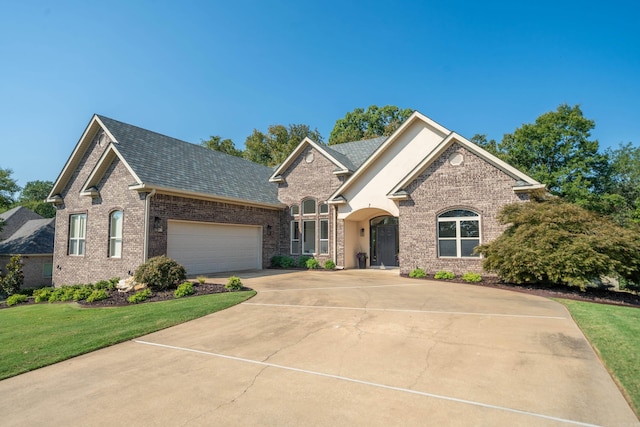 view of front of property with a garage and a front lawn