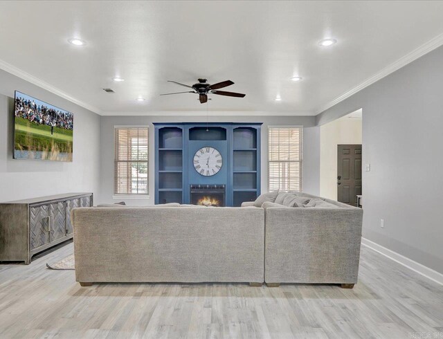 unfurnished living room with light hardwood / wood-style flooring, ceiling fan, and crown molding