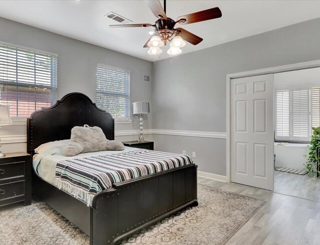 bedroom with ceiling fan and light hardwood / wood-style flooring