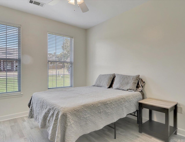 bedroom with ceiling fan and light hardwood / wood-style flooring