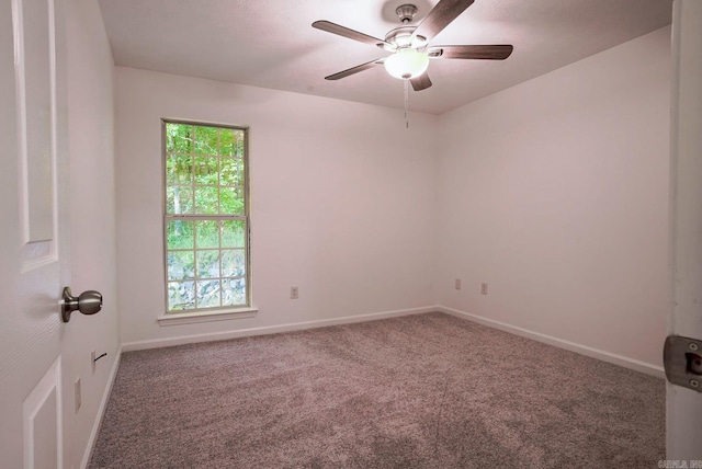 carpeted empty room featuring ceiling fan