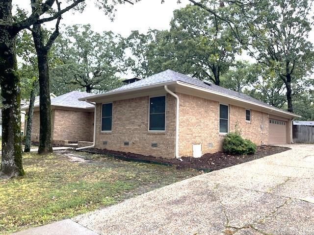 view of side of home featuring a yard and a garage