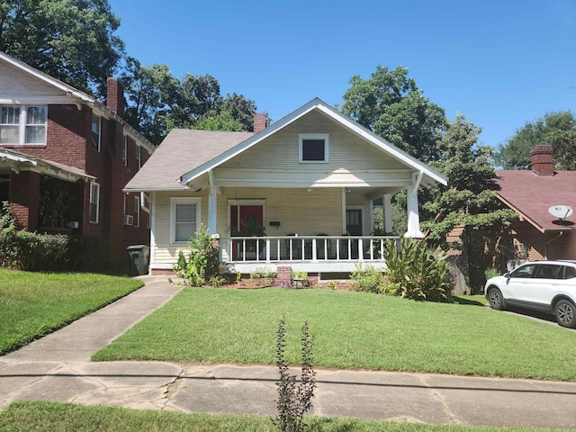 bungalow-style house with a porch and a front lawn