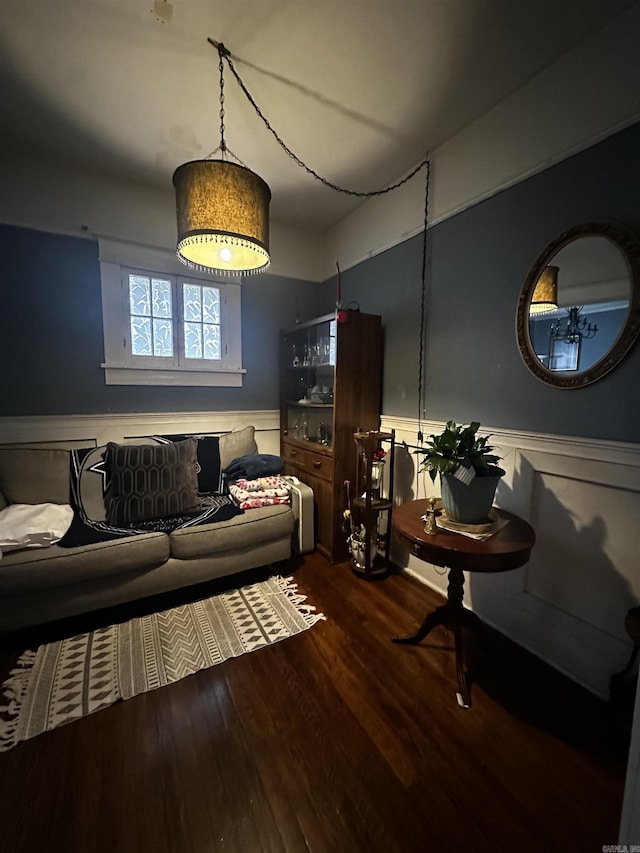 living room with a wainscoted wall and wood finished floors