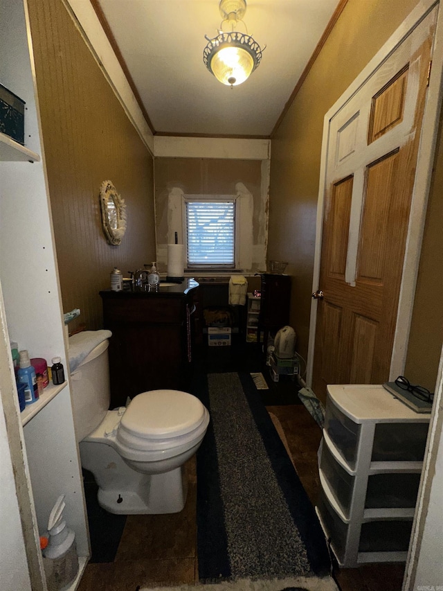 bathroom featuring toilet and crown molding