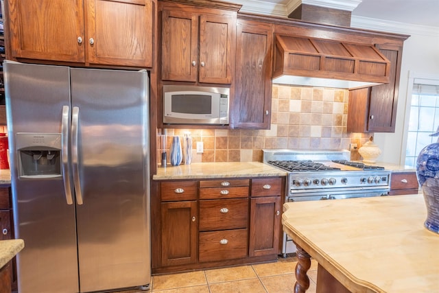 kitchen featuring light tile patterned floors, backsplash, stainless steel appliances, custom range hood, and crown molding