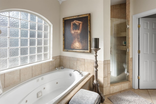 bathroom featuring shower with separate bathtub, toilet, and tile patterned floors