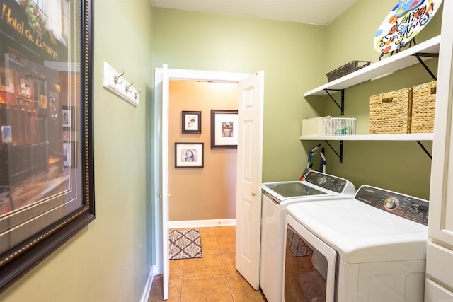 clothes washing area featuring light tile patterned floors and washing machine and clothes dryer