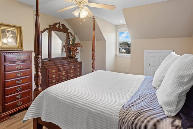 bedroom with light wood-type flooring, lofted ceiling, and ceiling fan