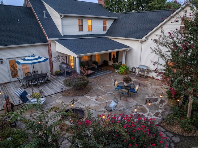 rear view of property featuring a deck