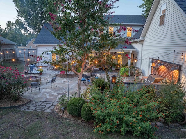 yard at dusk featuring a patio area