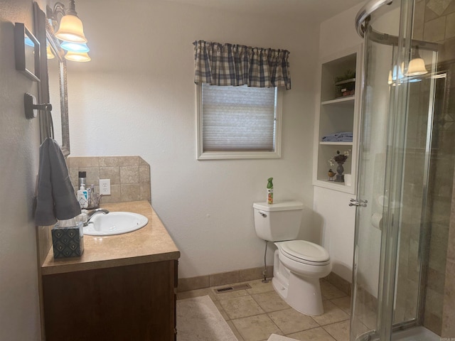 bathroom featuring vanity, a shower with shower door, toilet, and tile patterned flooring