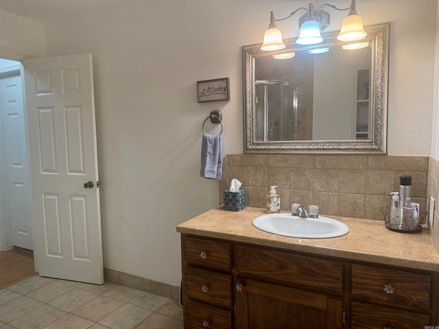 bathroom featuring decorative backsplash, tile patterned flooring, vanity, and a shower with door