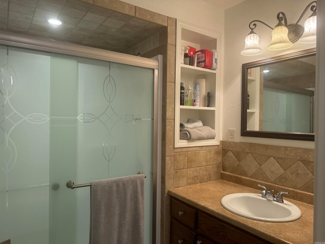 bathroom with built in shelves, walk in shower, and vanity