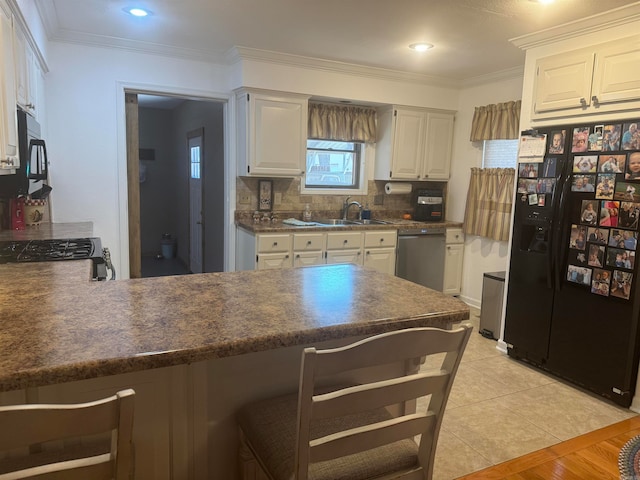 kitchen featuring ornamental molding, white cabinets, black appliances, and kitchen peninsula