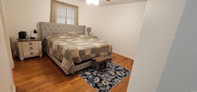 bedroom featuring wood-type flooring and ceiling fan