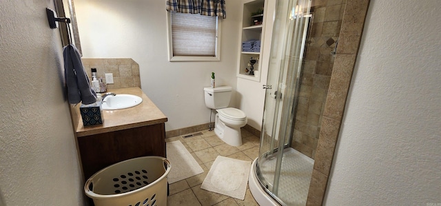 bathroom with vanity, toilet, tile patterned floors, and a shower with door