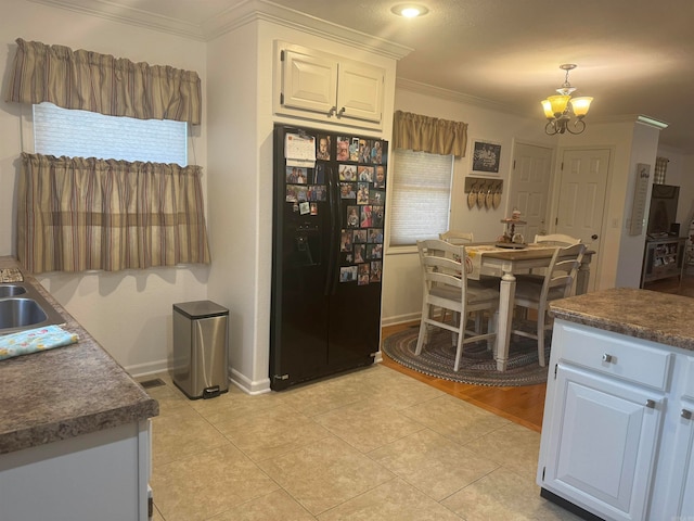 kitchen with light tile patterned flooring, an inviting chandelier, black fridge with ice dispenser, and white cabinetry