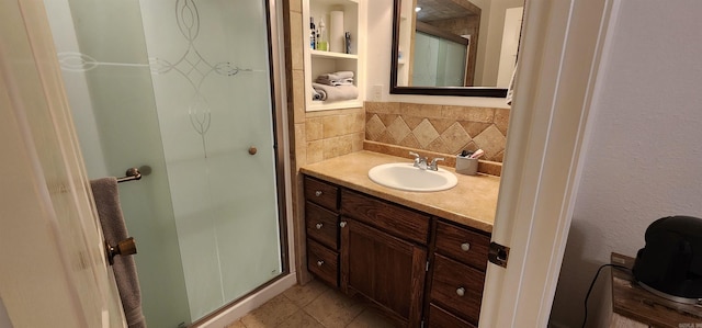 bathroom with vanity, backsplash, tile patterned flooring, and an enclosed shower