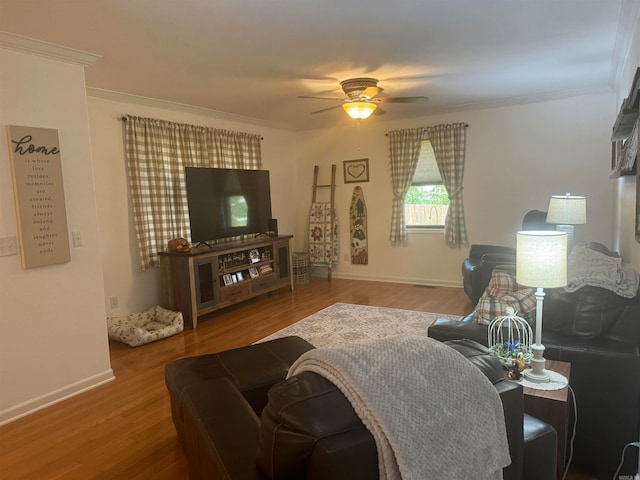 living room featuring ornamental molding, wood-type flooring, and ceiling fan