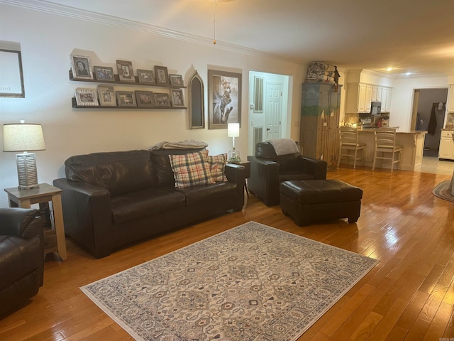 living room featuring ornamental molding and hardwood / wood-style floors