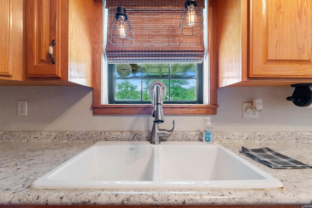 room details featuring light stone counters and sink