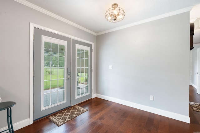 doorway featuring crown molding, dark hardwood / wood-style floors, french doors, and a notable chandelier