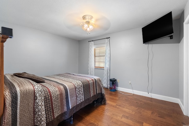 bedroom with ceiling fan and hardwood / wood-style floors