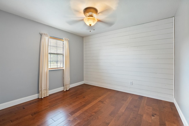 spare room with ceiling fan and dark wood-type flooring