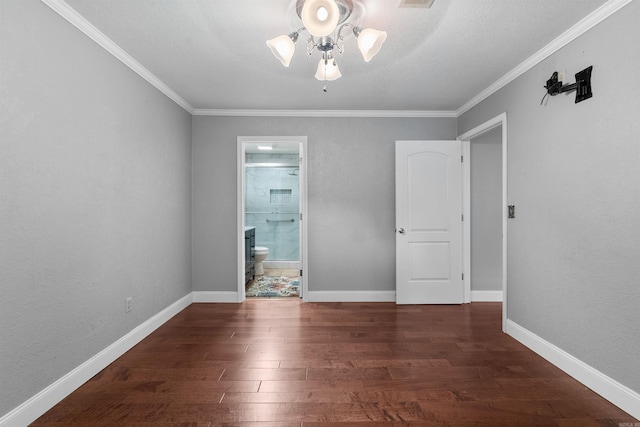 empty room featuring ceiling fan, crown molding, and dark hardwood / wood-style flooring