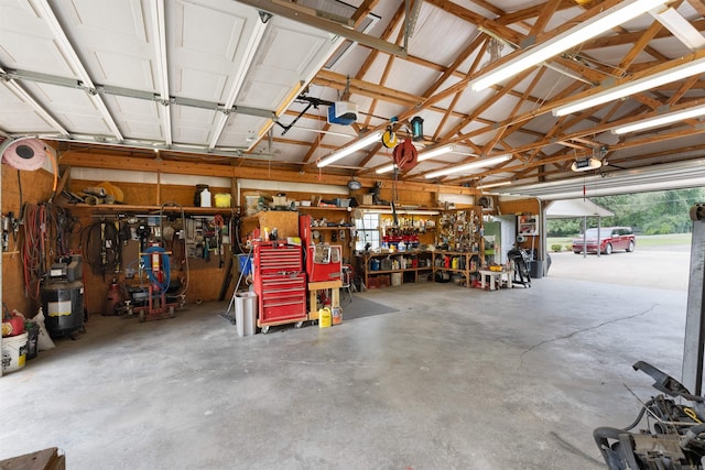 garage with a garage door opener and a workshop area