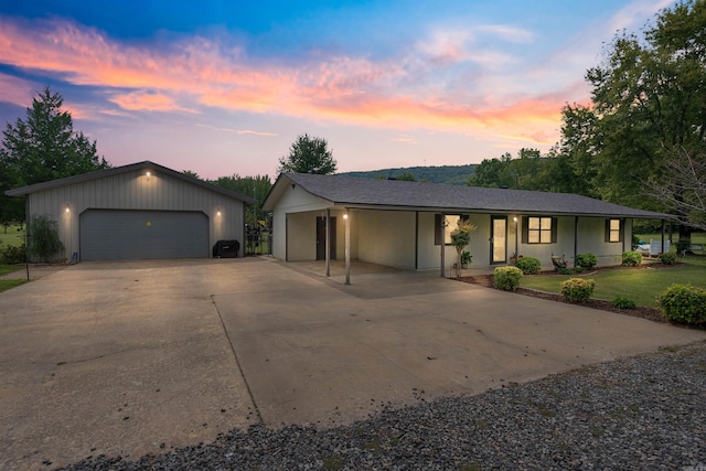 ranch-style home featuring covered porch and a garage