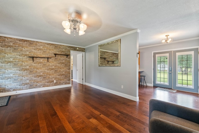 unfurnished living room with a textured ceiling, ornamental molding, dark hardwood / wood-style floors, and ceiling fan