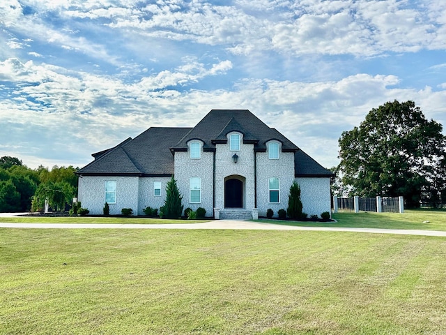 french country style house featuring a front yard