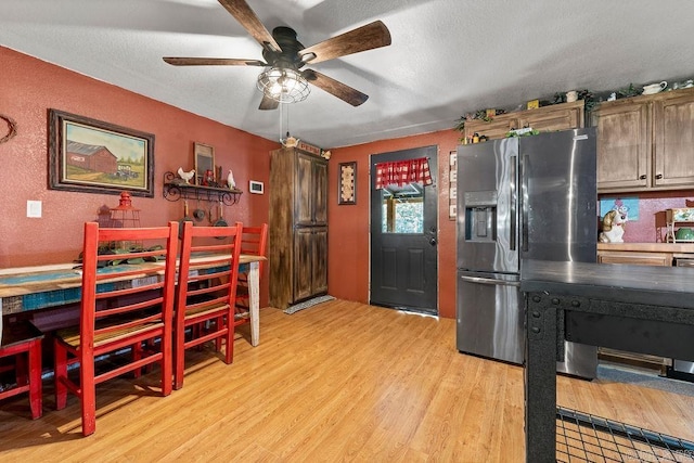 kitchen with stainless steel fridge, a textured ceiling, light hardwood / wood-style floors, and ceiling fan