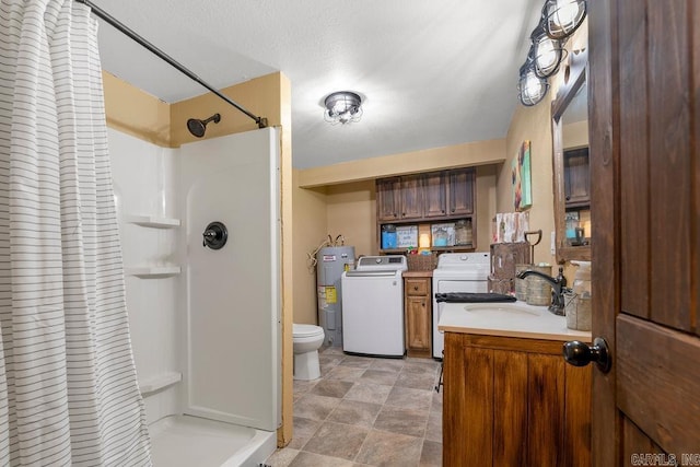 bathroom featuring a shower with shower curtain, vanity, water heater, separate washer and dryer, and toilet