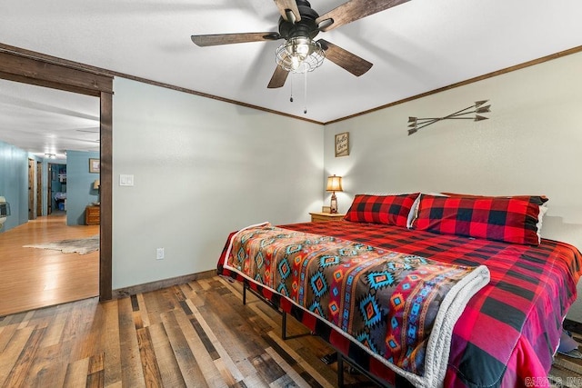 bedroom with hardwood / wood-style flooring, ceiling fan, and ornamental molding