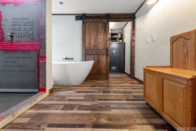 bathroom with hardwood / wood-style flooring and a bathtub