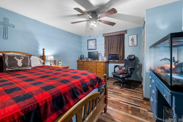 bedroom with hardwood / wood-style flooring and ceiling fan