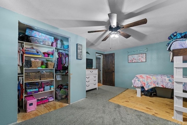 carpeted bedroom with a closet and ceiling fan