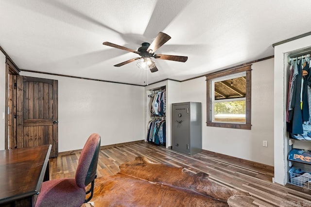 office space featuring hardwood / wood-style flooring, ceiling fan, and ornamental molding