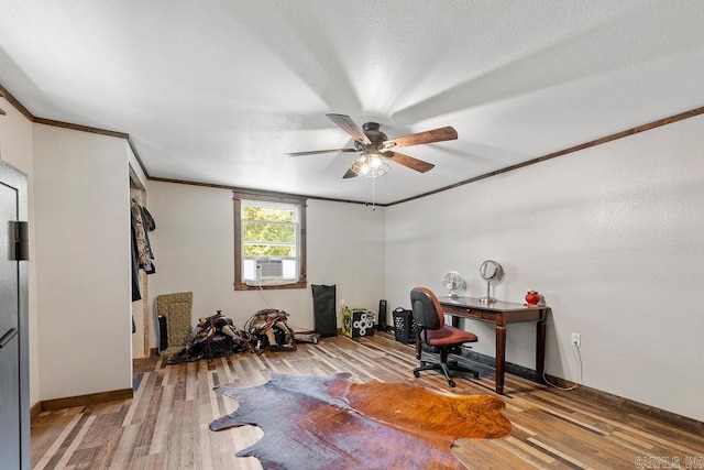 home office with light wood-type flooring, a textured ceiling, ceiling fan, crown molding, and cooling unit