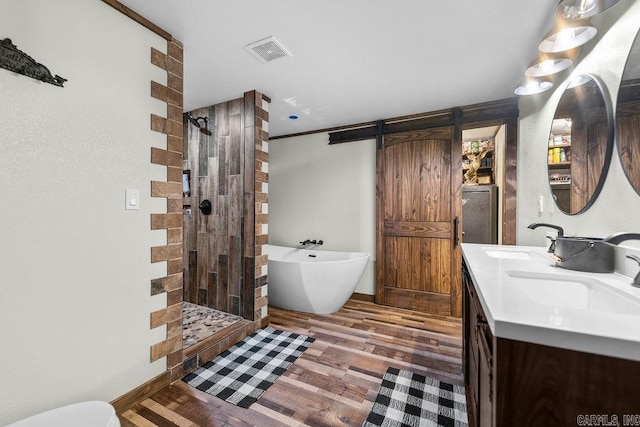 bathroom featuring hardwood / wood-style floors, vanity, and separate shower and tub