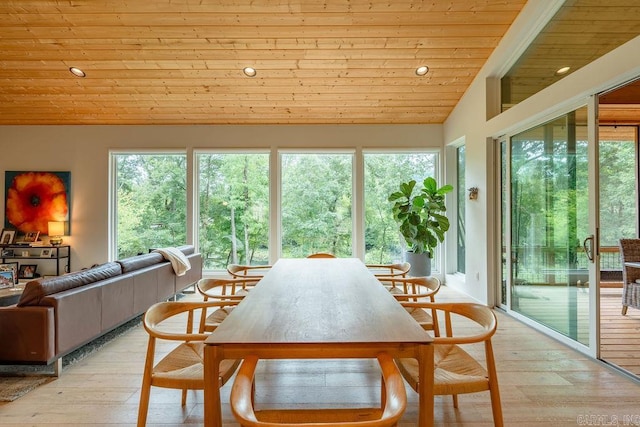 dining room featuring lofted ceiling, wood ceiling, and light hardwood / wood-style flooring