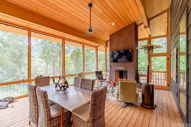 sunroom / solarium with vaulted ceiling with beams and wood ceiling