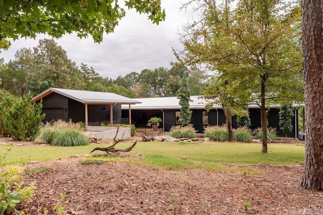 back of house with a lawn