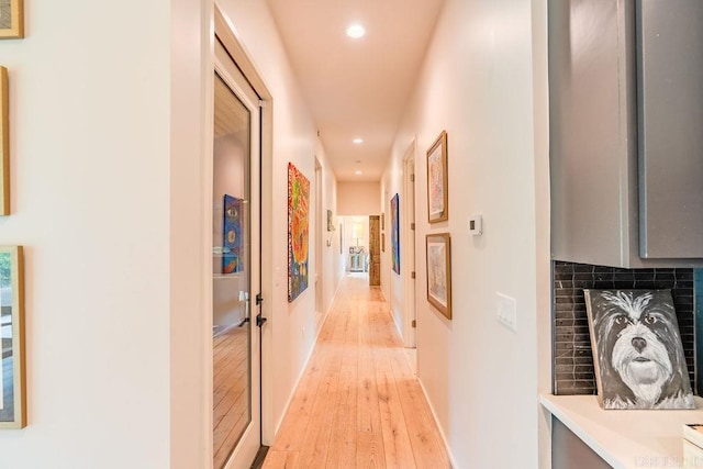 corridor with light wood-type flooring