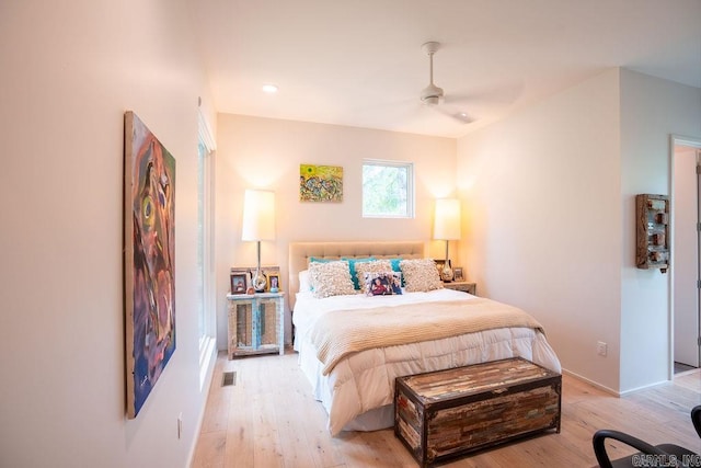 bedroom with light hardwood / wood-style floors and ceiling fan